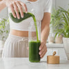 Filling the free glass water bottle with Verdia chlorophyll water